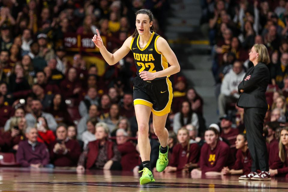 Caitlin Clark reacts to hitting a three-point basket against Minnesota.