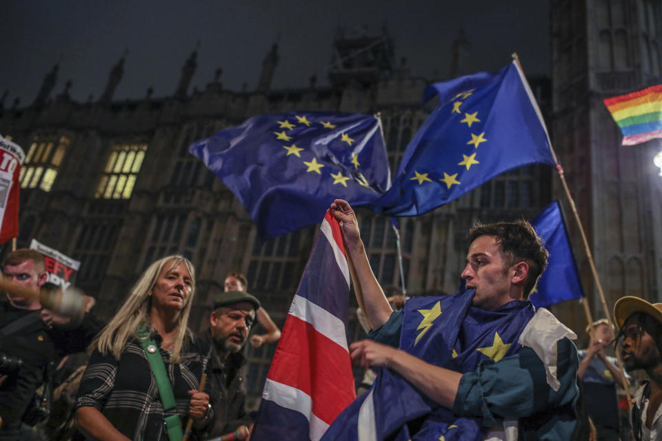 Protesters outside the House of Commons, London, Tuesday, Sept. 3, 2019. British Prime Minister Boris Johnson suffered key defections from his party Tuesday, losing a working majority in Parliament and weakening his position as he tried to prevent lawmakers from blocking his Brexit plans. (AP Photo/Vudi Xhymshiti)