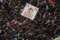 Supporters of Pakistan's former Prime Minister Imran Khan's 'Pakistan Tehreek-e-Insaf' party attend a rally, in Rawalpindi, Pakistan, Saturday, Nov. 26, 2022. Khan said Saturday his party was quitting the country's regional and national assemblies, as he made his first public appearance since being wounded in a gun attack earlier this month. (AP Photo/Anjum Naveed)