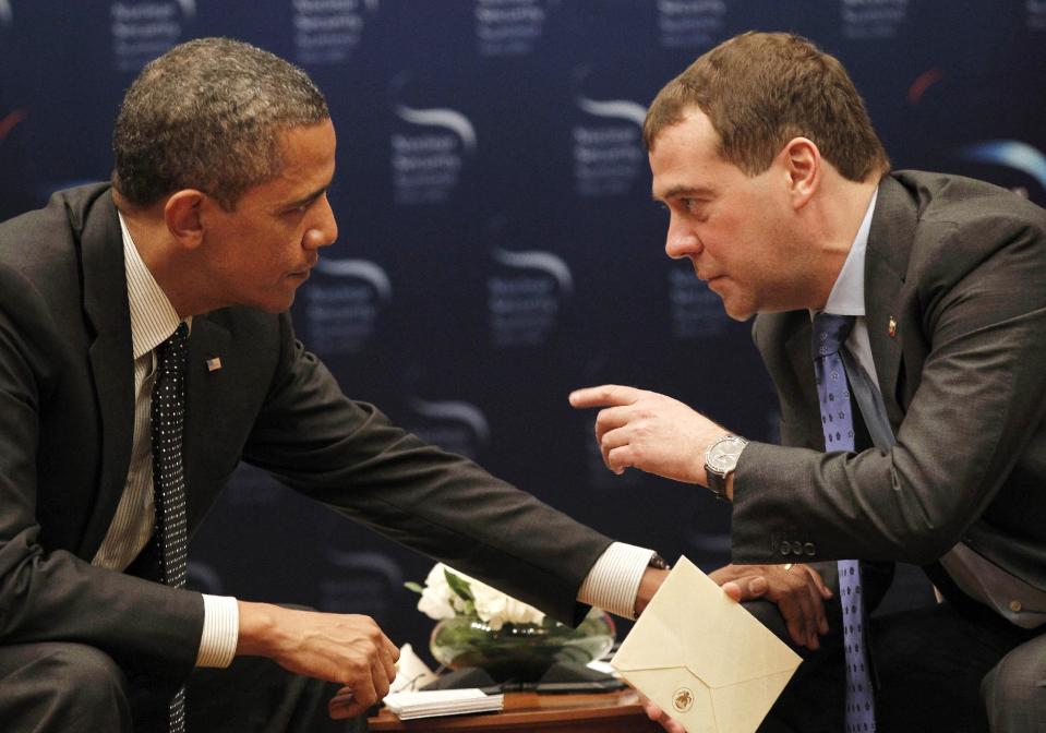 FILE -In this March 26, 2012 file photo, President Barack Obama talks with Russian President Dmitry Medvedev in Seoul, South Korea. President Barack Obama will play host this weekend to an extraordinary confluence of international summitry, with world leaders scuttling from the Maryland mountains to downtown Chicago as they grapple for fixes to Europe's mounting economic woes and solidify plans for winding down the decade-long war in Afghanistan. (AP Photo/Pablo Martinez Monsivais, File)