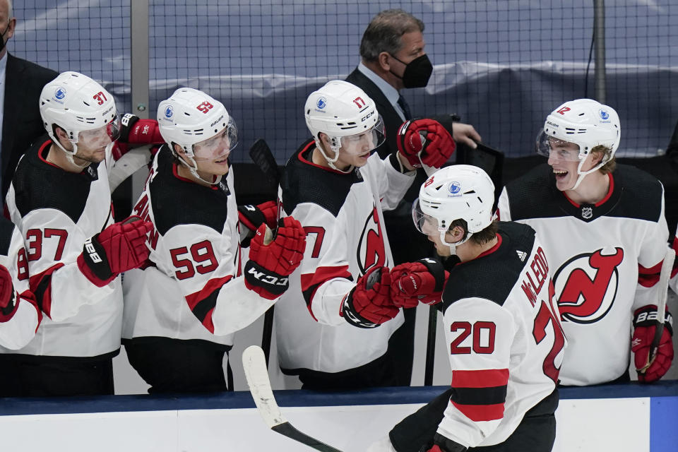 New Jersey Devils' Michael McLeod (20) celebrates with teammates after scoring a goal during the second period of the team's NHL hockey game against the New York Islanders on Thursday, May 6, 2021, in Uniondale, N.Y. (AP Photo/Frank Franklin II)