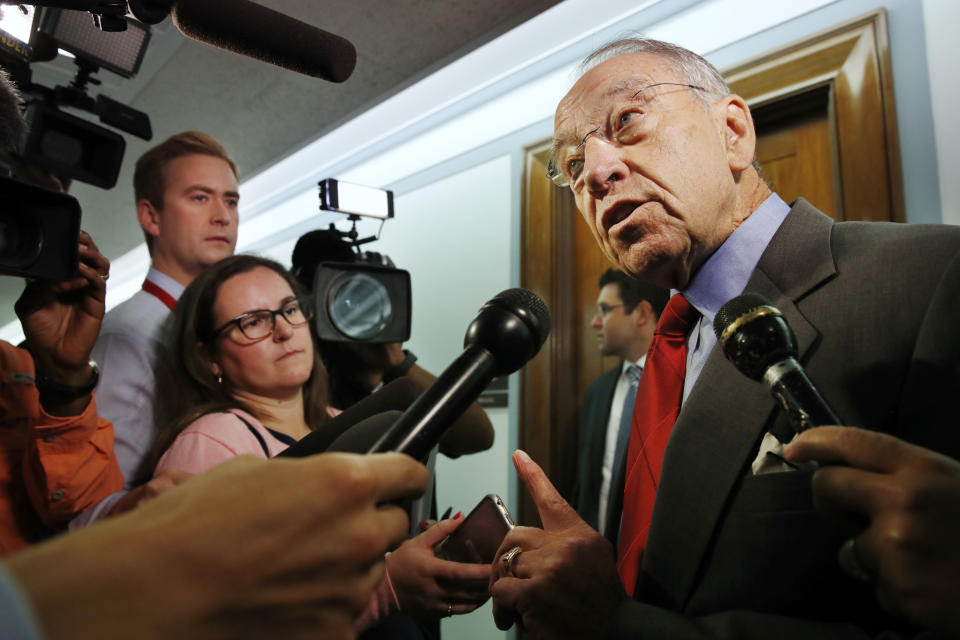 Sen. Chuck Grassley, R-Iowa, right, answers questions from reporters about allegations of sexual misconduct against Supreme Court nominee Brett Kavanaugh, Wednesday, Sept. 26, 2018, as he arrives for a Senate Finance Committee hearing on Capitol Hill in Washington. (AP Photo/Jacquelyn Martin)