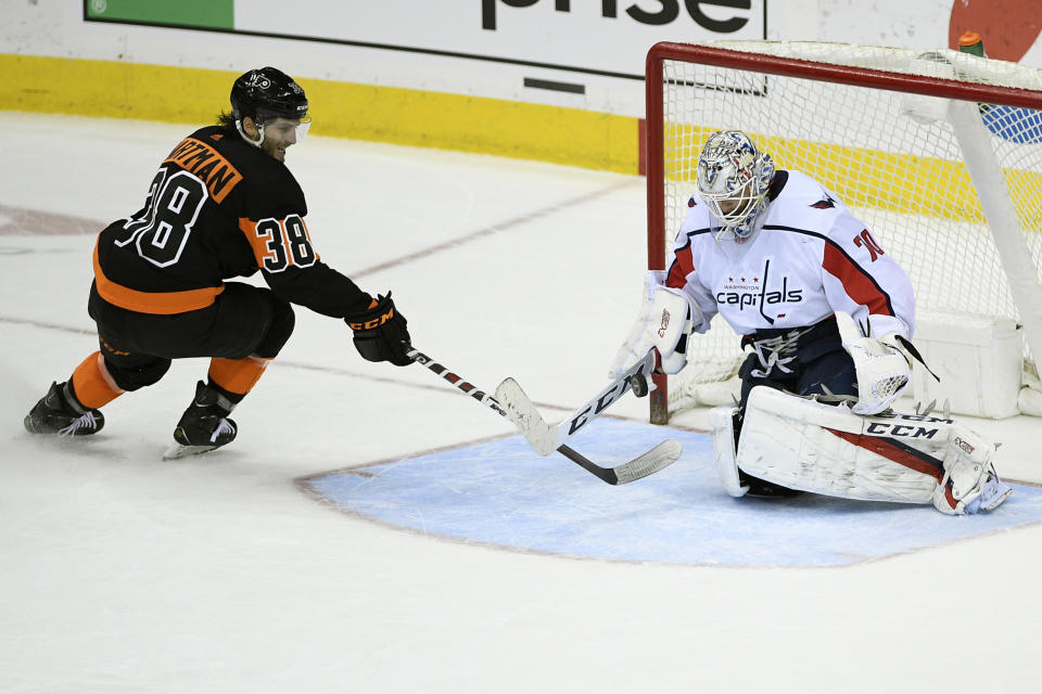 Washington Capitals goaltender Braden Holtby (70) stops the puck against Philadelphia Flyers right wing Ryan Hartman (38) during the third period of an NHL hockey game, Sunday, March 24, 2019, in Washington. The Capitals won 3-1. (AP Photo/Nick Wass)