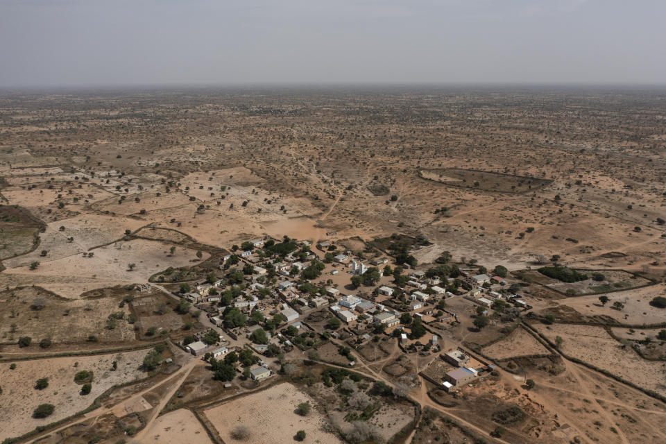 A desolate, semi-arid landscape surrounds the Sahel village of Ndiawagne Fall in Kebemer, Senegal, on Friday, Nov. 5, 2021. The region is on one end of a project called “Great Green Wall” that was once envisioned as a way for Africa to fight climate change. The idea behind the stalled project was to plant a 5,000-mile line of trees that would span the entire continent and hold back the Sahara Desert. (AP Photo/Leo Correa)