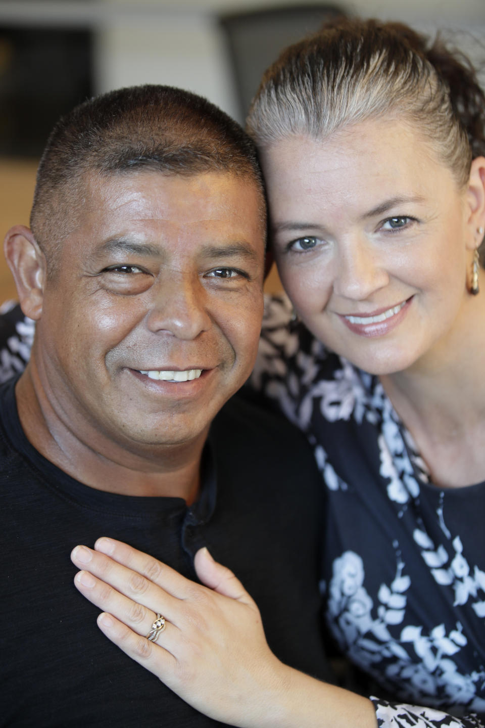 Donaldo Morales, left, and his wife Isleen Gimenez Morales, right, pose for a photograph at an attorney's office in Kansas City, Mo., Tuesday, Sept. 17, 2019. (AP Photo/Orlin Wagner)