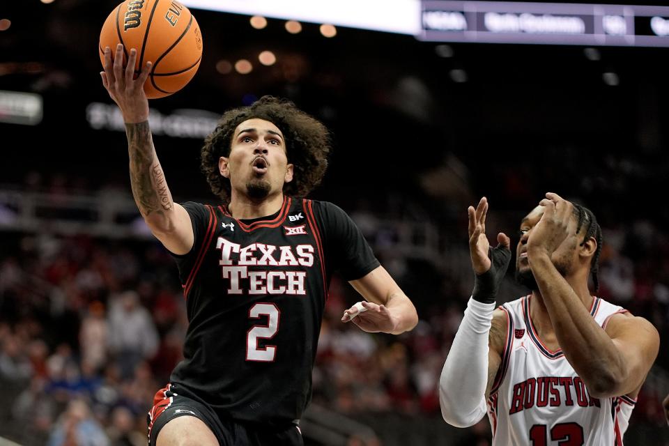 Texas Tech guard Pop Isaacs (2) gets past Houston forward J'Wan Roberts (13) to put up a shot during the semifinal round of the Big 12 Conference tournament, Friday, March 15, 2024, in Kansas City, Mo.