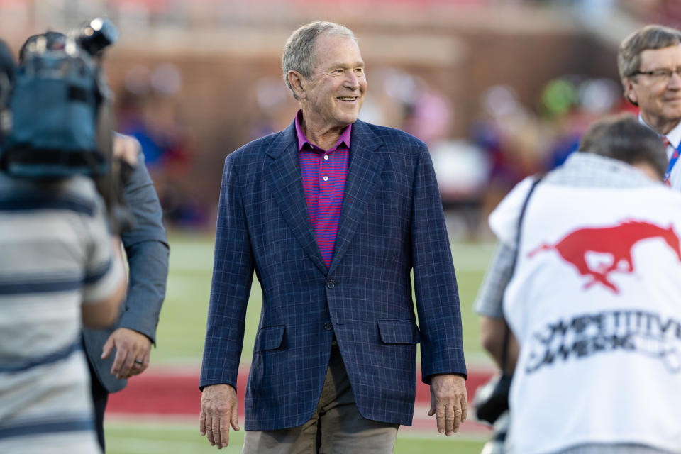 DALLAS, TX - OCTOBER 14: Former President George W. Bush smiles before the coin toss during the college football game between the SMU Mustangs and the Navy Midshipmen on October 14, 2022, at Gerald J. Ford Stadium in Dallas, TX.  (Photo by Matthew Visinsky/Icon Sportswire via Getty Images)