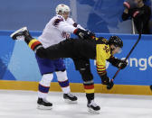 <p>Henrik Odegaard (42), of Norway, checks Marcel Noebels (92), of Germany, during the first period of the preliminary round of the men’s hockey game at the 2018 Winter Olympics in Gangneung, South Korea, Sunday, Feb. 18, 2018. (AP Photo/Matt Slocum) </p>