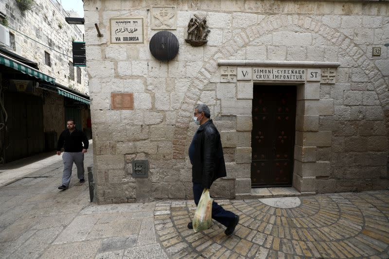 A man walks past a bronze sculpture by Italian artist Alessandro Mutto at one of the Stations of the Cross along the Via Dolorosa, amid the coronavirus disease (COVID-19) outbreak in Jerusalem's Old City