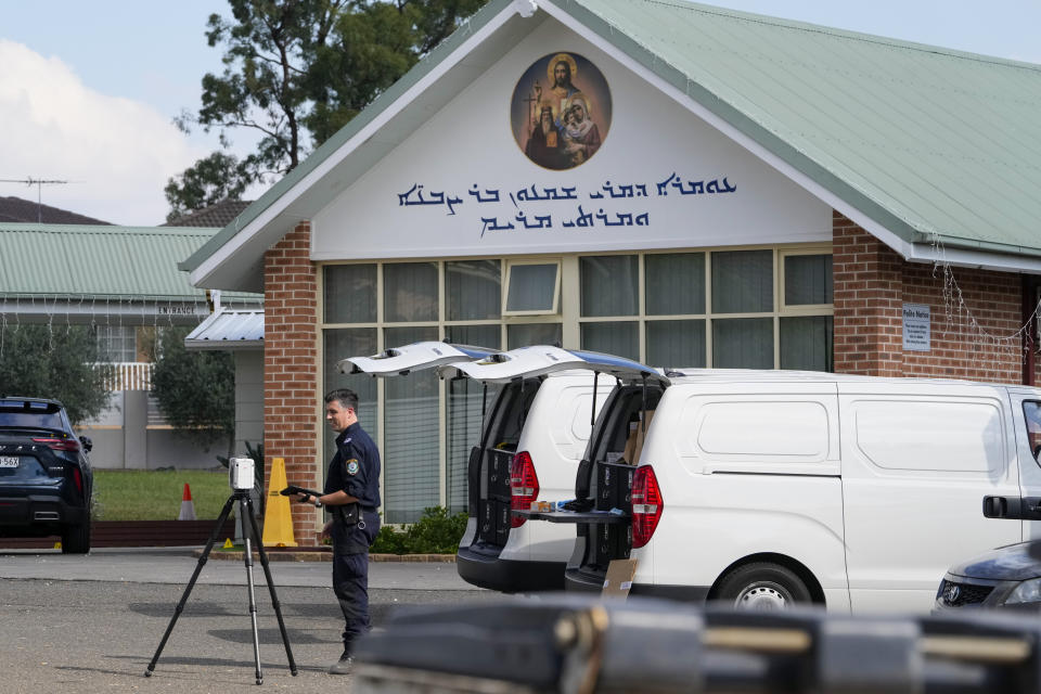 A police forensic officer works at a crime scene at the Christ the Good Shepherd Church in suburban Wakely in western Sydney, Australia, Tuesday, April 16, 2024. Australian police say a knife attack in Sydney that wounded a bishop and a priest during a church service as horrified worshippers watched online and in person, and sparked a riot was an act of terrorism. (AP Photo/Mark Baker)