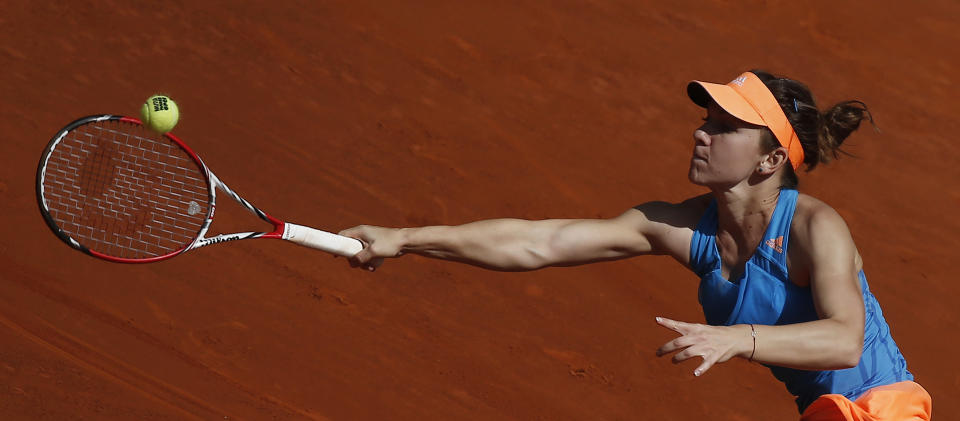 Simona Halep from Romania returns the ball during a Madrid Open tennis tournament semifinal match against Petra Kvitova from the Czech Republic in Madrid, Spain, Saturday, May 10, 2014. (AP Photo/Andres Kudacki)