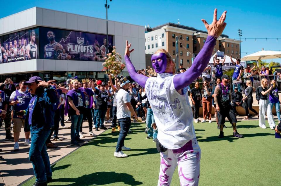 Kings fan Jon Lardy was decked out with purple body paint and a purple opera mask worn on the back of his headwhile getting people reved up in front of Golden 1 Center prior to game one of the playoffs against the Golden State Warriors on Saturday, April 15, 2023.