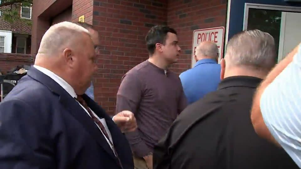 Philadelphia police Officer Mark Dial, center, on September 8 turned himself in on a criminal warrant related to the fatal shooting of Eddie Irizarry. - WPVI