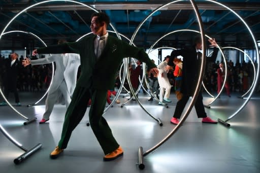 Zoot suit: Models pose between cyr wheels at the Issey Miyake men's fashion week show in Paris