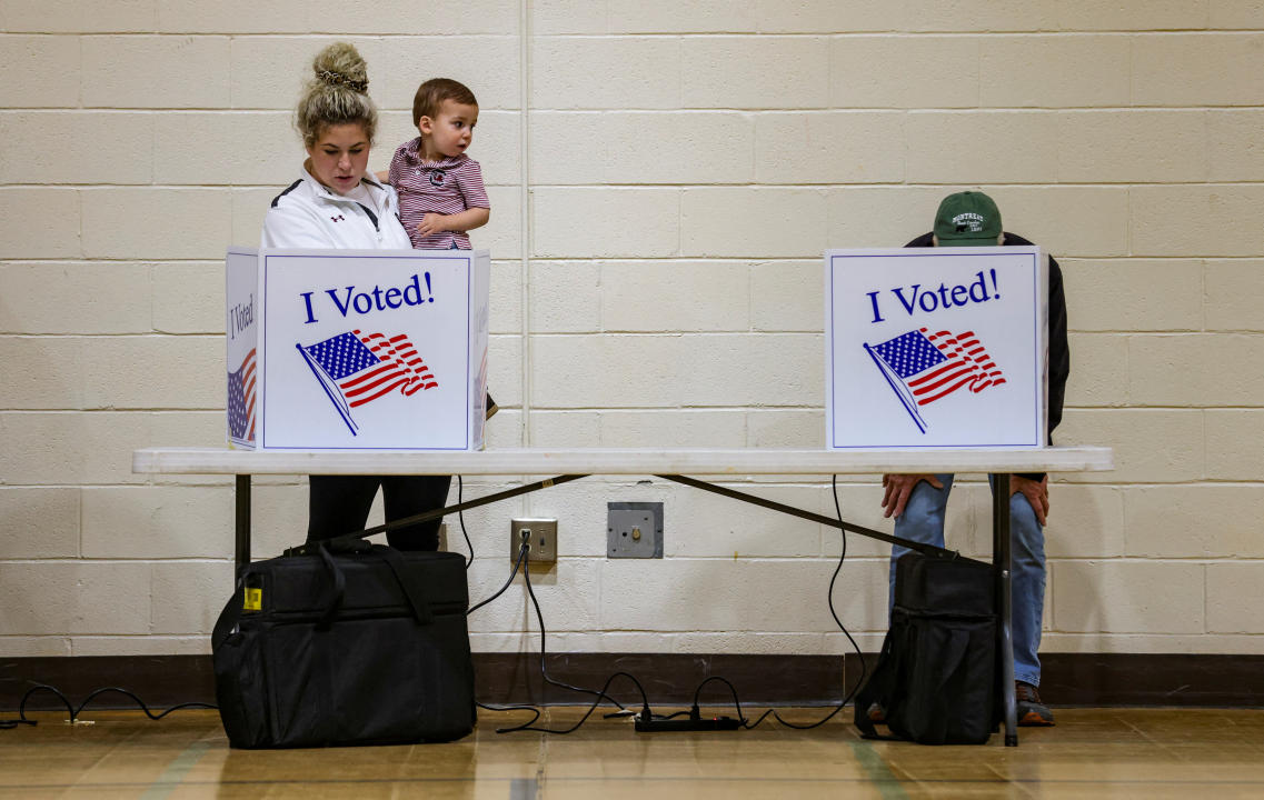 Stephanie Scott holds Jack, 2, while voting.