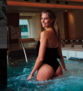 <p>The 27-year-old model shows off her perky derriere in a black one-piece posing in a hotel spa.</p>