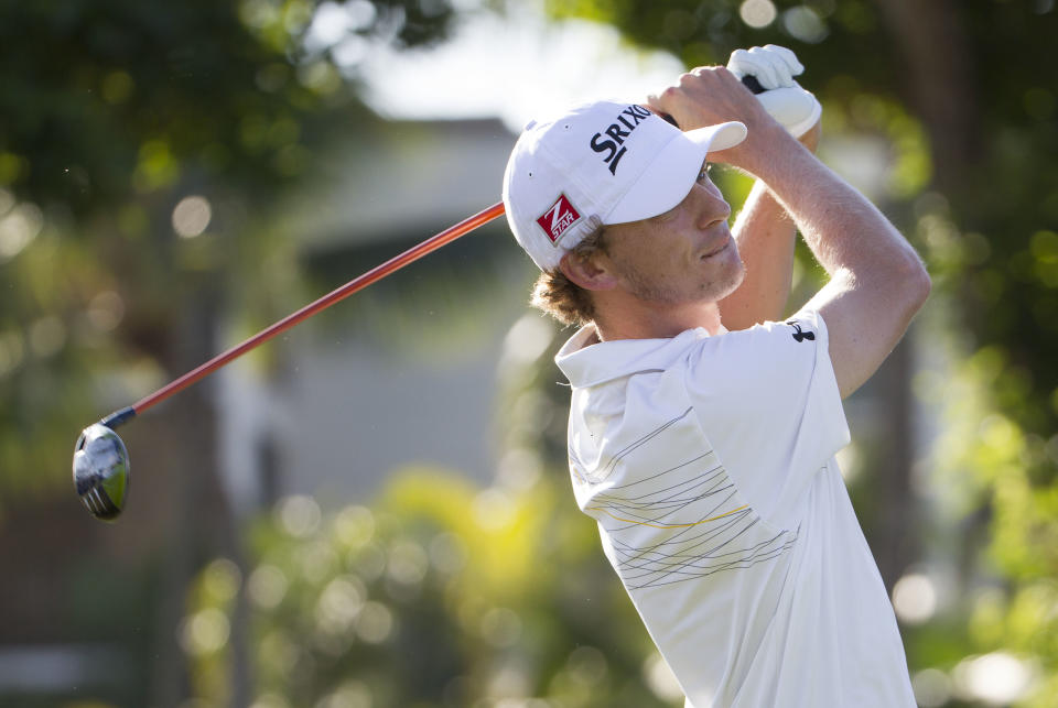 Will Wilcox watches the flight of his golf ball off the first tee during the third round of the Sony Open golf tournament at Waialae Country Club, Saturday, Jan. 11, 2014, in Honolulu. (AP Photo/Eugene Tanner)