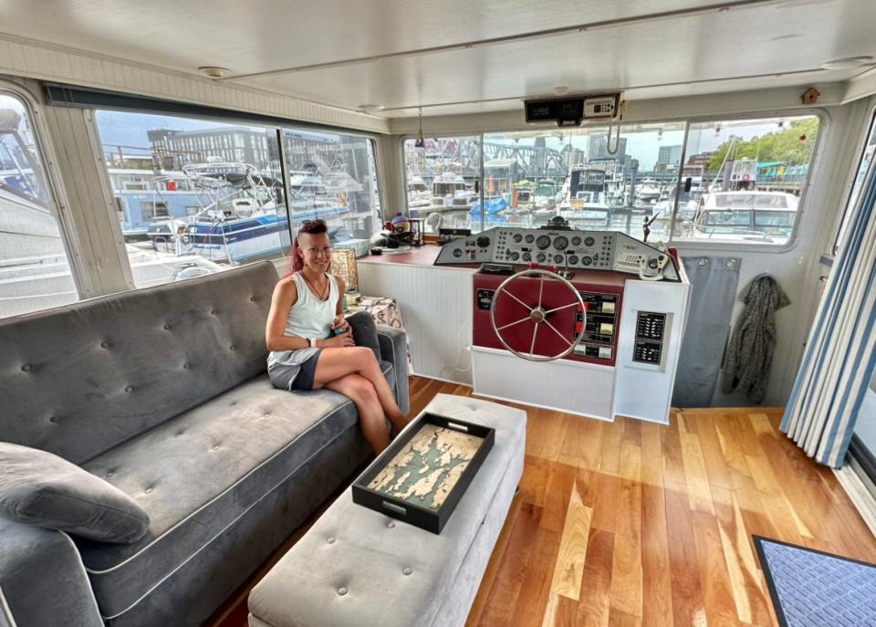 Stacy Rae sits in the living room of her 50-foot houseboat, where she is one of the few year-round residents at the Providence Marina.