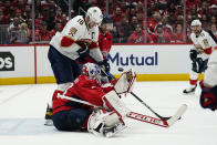 Washington Capitals goaltender Ilya Samsonov (30) tries to grab the puck with Florida Panthers center Aleksander Barkov (16) nearby during the second period of Game 4 in the first round of the NHL Stanley Cup hockey playoffs, Monday, May 9, 2022, in Washington. (AP Photo/Alex Brandon)