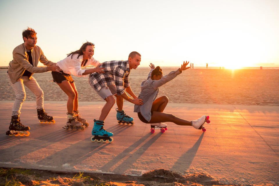 Friends skating on a boardwalk
