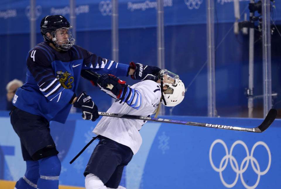 <p>Monique Lamoureux-Morando (7), of the United States, takes a punch from Rosa Lindstedt (4), of Finland, during the second period of the preliminary round of the womenâs hockey game at the 2018 Winter Olympics in Gangneung, South Korea, Sunday, Feb. 11, 2018. (AP Photo/Frank Franklin II) </p>