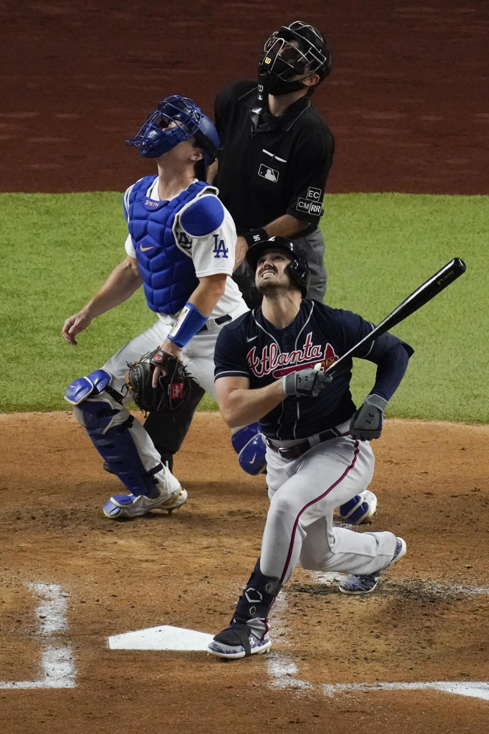 Atlanta Braves' Adam Duvall grimaces after a swing during the second inning in Game 1 of a baseball National League Championship Series against the Los Angeles Dodgers Monday, Oct. 12, 2020, in Arlington, Texas. Duvall left the game with an injury. (AP Photo/Sue Ogrocki)