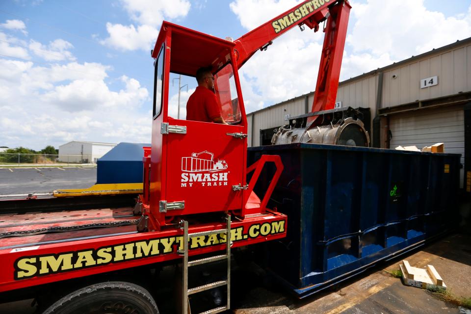 Smash My Trash driver Tom Back operates a machine designed to smash materials in roll off dumpsters on Friday, Aug. 5, 2022.