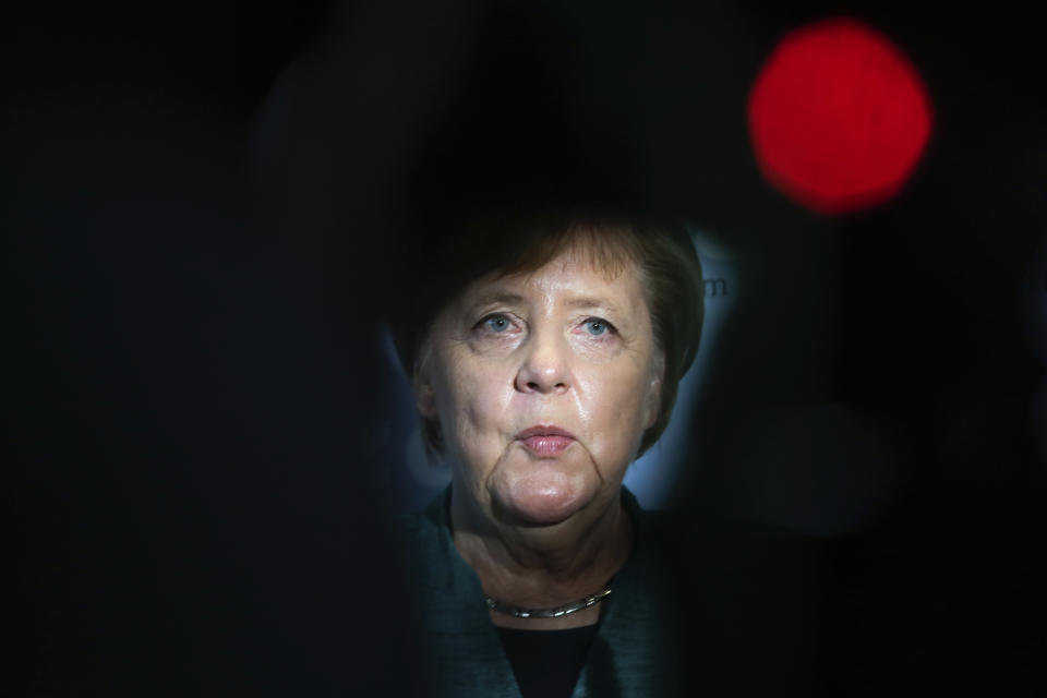 German Chancellor Angela Merkel delivers a statement during a faction meeting of her ruling Christian Union parties faction at the Reichstag building in Berlin, Tuesday, Sept. 25, 2018. (AP Photo/Markus Schreiber)