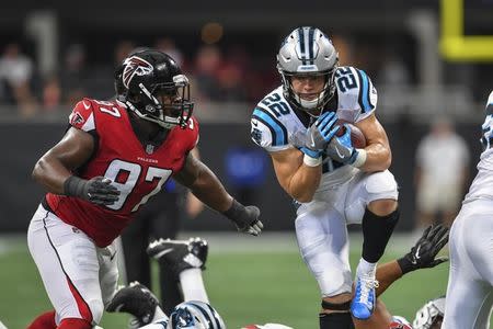 FILE PHOTO: Sep 16, 2018; Atlanta, GA, USA; Carolina Panthers running back Christian McCaffrey (22) jumps through the line against Atlanta Falcons defensive tackle Grady Jarrett (97) during the first half at Mercedes-Benz Stadium. Mandatory Credit: Dale Zanine-USA TODAY Sports/File Photo