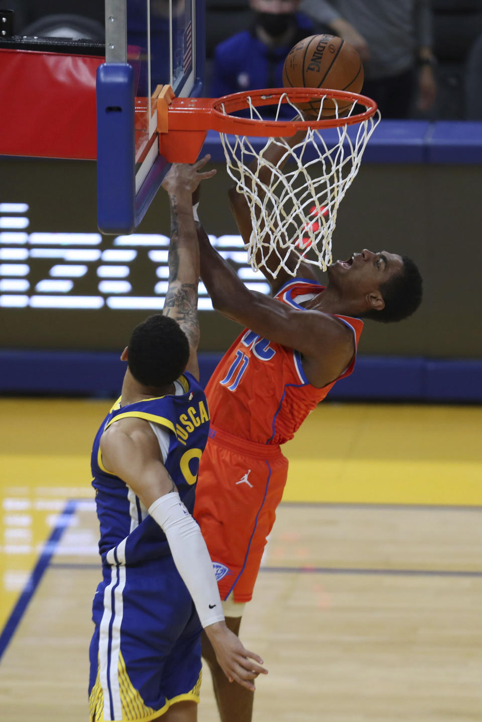 Oklahoma City Thunder's Théo Maledon, right, shoots against Golden State Warriors' Juan Toscano-Anderson during the second half of an NBA basketball game in San Francisco, Saturday, May 8, 2021. (AP Photo/Jed Jacobsohn)