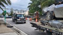 Vehicles that were pulled from the rubble of the Champlain Towers South are transported on Saturday, July 10, 2021 in Surfside, Fla. Surfside Mayor Charles Burkett said crews were making good progress, especially in clearing debris from the section of the building that didn’t collapse but was later demolished. That section will likely be cleared sooner than originally expected, he said. (AP Photo/David Fischer)