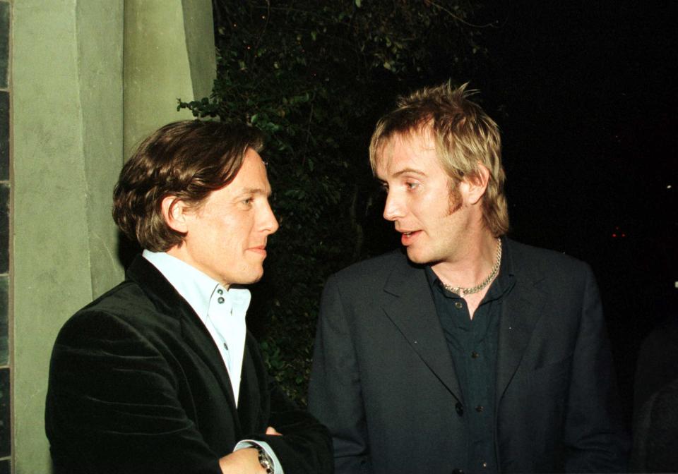 01/22/00. Beverly Hills, Ca. Hugh Grant Shares A Moment With Rhys Ifans Who Played His Room-Mate Spike, In The Hit Movie 