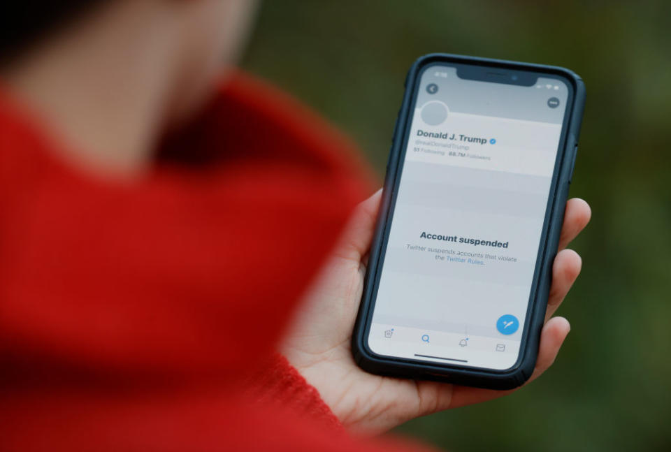 The suspended Twitter account of Donald Trump appears on an iPhone screen.
