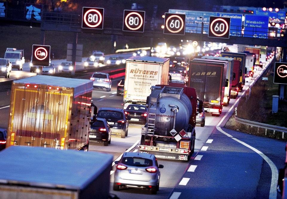 FILE - In this Tuesday, Dec. 4, 2018 file photo, trucks line up on a highway in Frankfurt, Germany. Germany's parliament is poised to more than double the starting price for carbon dioxide emissions from the transport and heating industries when the charge is introduced in 2021. (AP Photo/Michael Probst, file)