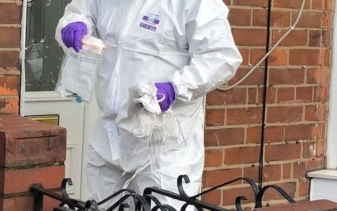 A forensic officer carrying evidence in Raglan Street - Credit: MEN Media/Hull Daily Mail&nbsp;