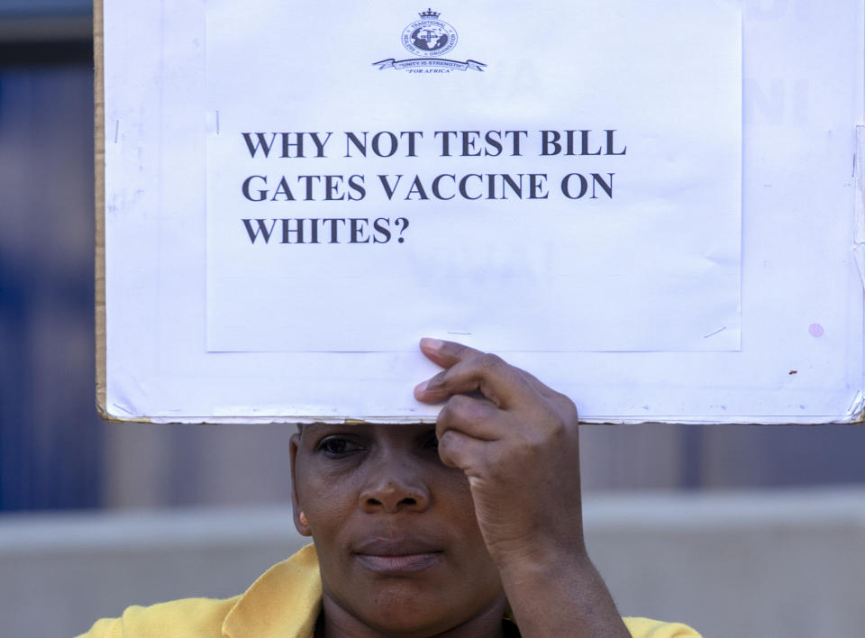 A woman holds a placard to protest against Coronavirus trials in Africa, outside the University of the Witwatersrand in Johannesburg, South Africa, Wednesday, July 1, 2020. A protest against Africa’s first COVID-19 vaccine trial is underway as experts note a worrying level of resistance and misinformation around testing on the continent. (AP Photo/Themba Hadebe)