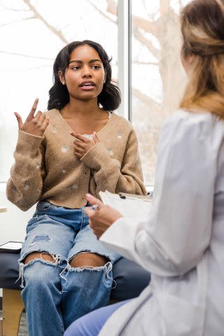 <p>Getty Images</p> College student talking to doctor