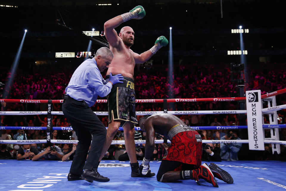 Tyson Fury, of England, knocks down Deontay Wilder in a heavyweight championship boxing match Saturday, Oct. 9, 2021, in Las Vegas. (AP Photo/Chase Stevens)