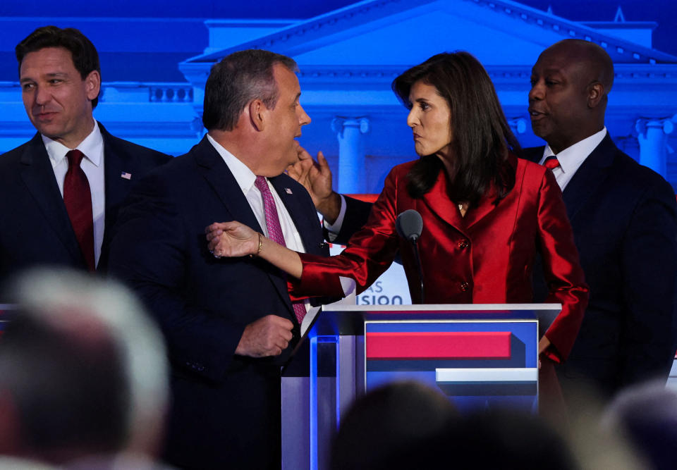 Florida Gov. Ron DeSantis, former New Jersey Gov. Chris Christie, former South Carolina Gov. Nikki Haley and Sen. Tim Scott of South Carolina mingle onstage after the second GOP debate.