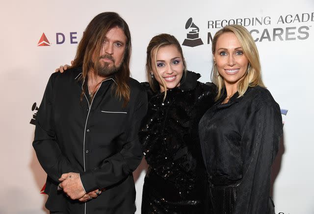 <p>Kevin Mazur/Getty</p> Billy Ray, Miley and Tish Cyrus in 2019