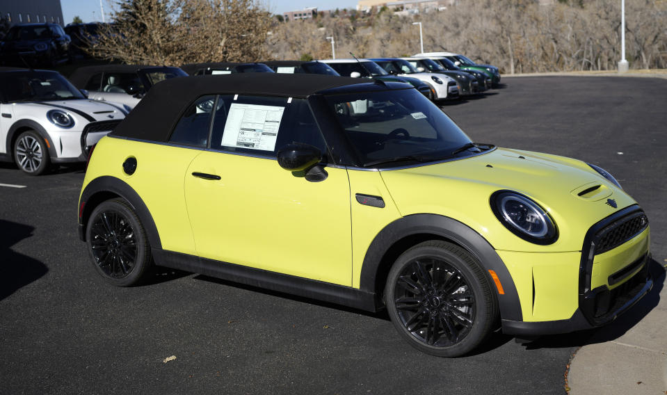 Unsold 2024 Cooper S convertibles are displayed at a Mini dealership on Nov. 12, 2023, in Highlands Ranch, Colo. Undeterred by high prices, rising interest rates, autoworker strikes and a computer chip shortage that slowed assembly lines, American consumers still bought 15.5 million new vehicles last year, 11% more than in 2022. (AP Photo/David Zalubowski)
