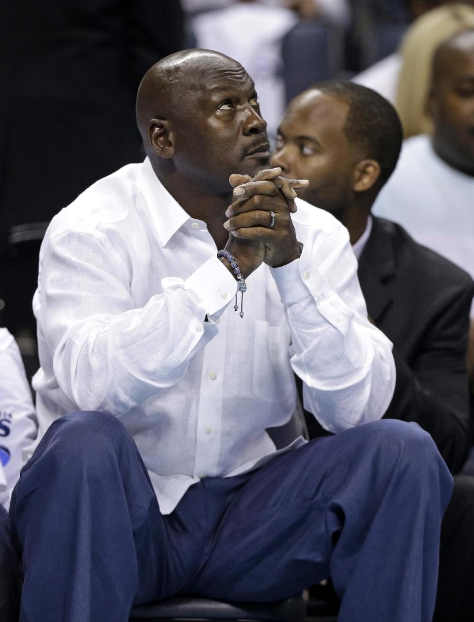 Charlotte Bobcats owner Michael Jordan looks up at the scoreboard during the first half in Game 3 of an opening-round NBA basketball playoff series against the Miami Heat in Charlotte, N.C., Saturday, April 26, 2014. (AP Photo/Chuck Burton)