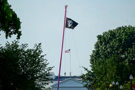 The activist group Extinction Rebellion flies their flag near the White House during a climate change protest in Washington