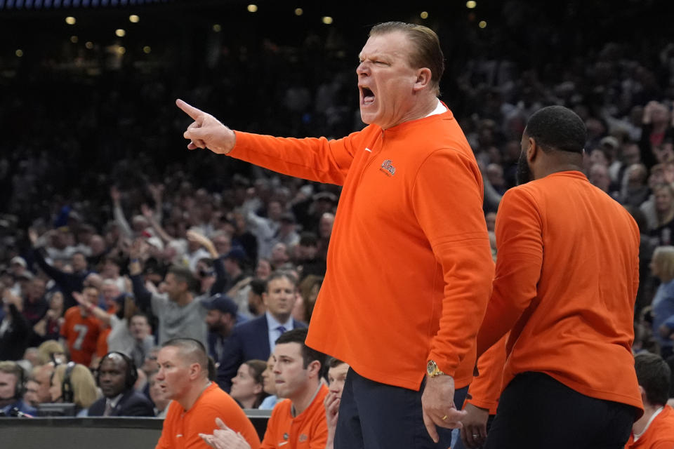 Illinois head coach Brad Underwood calls to officials during the first half of the Elite 8 college basketball game against UConn in the men's NCAA Tournament, Saturday, March 30, 2024, in Boston. (AP Photo/Steven Senne)