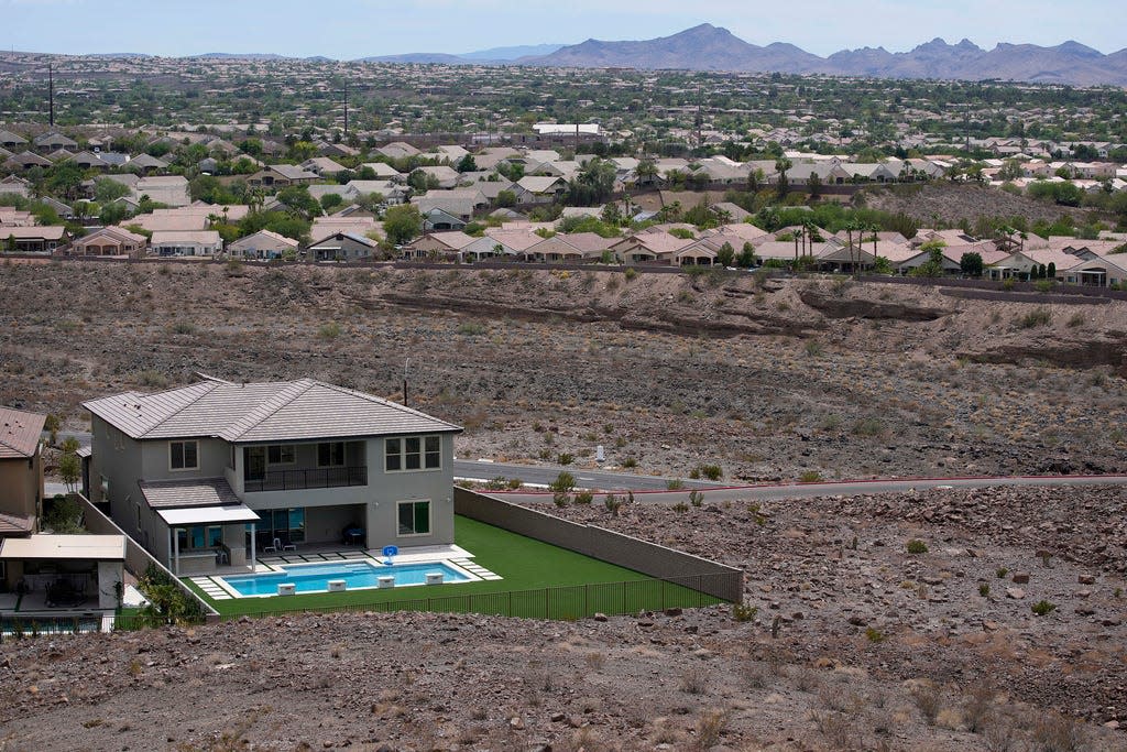 A home with a swimming pool abuts the desert on the edge of the Las Vegas valley July 20, 2022, in Henderson, Nev. Nevada lawmakers on Monday, March 13, 2023, will consider another shift in water use for one of the driest major metropolitan areas in the U.S. The water agency that manages the Colorado River supply for Vegas is seeking authority to limit what comes out of residents' taps. (AP Photo/John Locher, File)