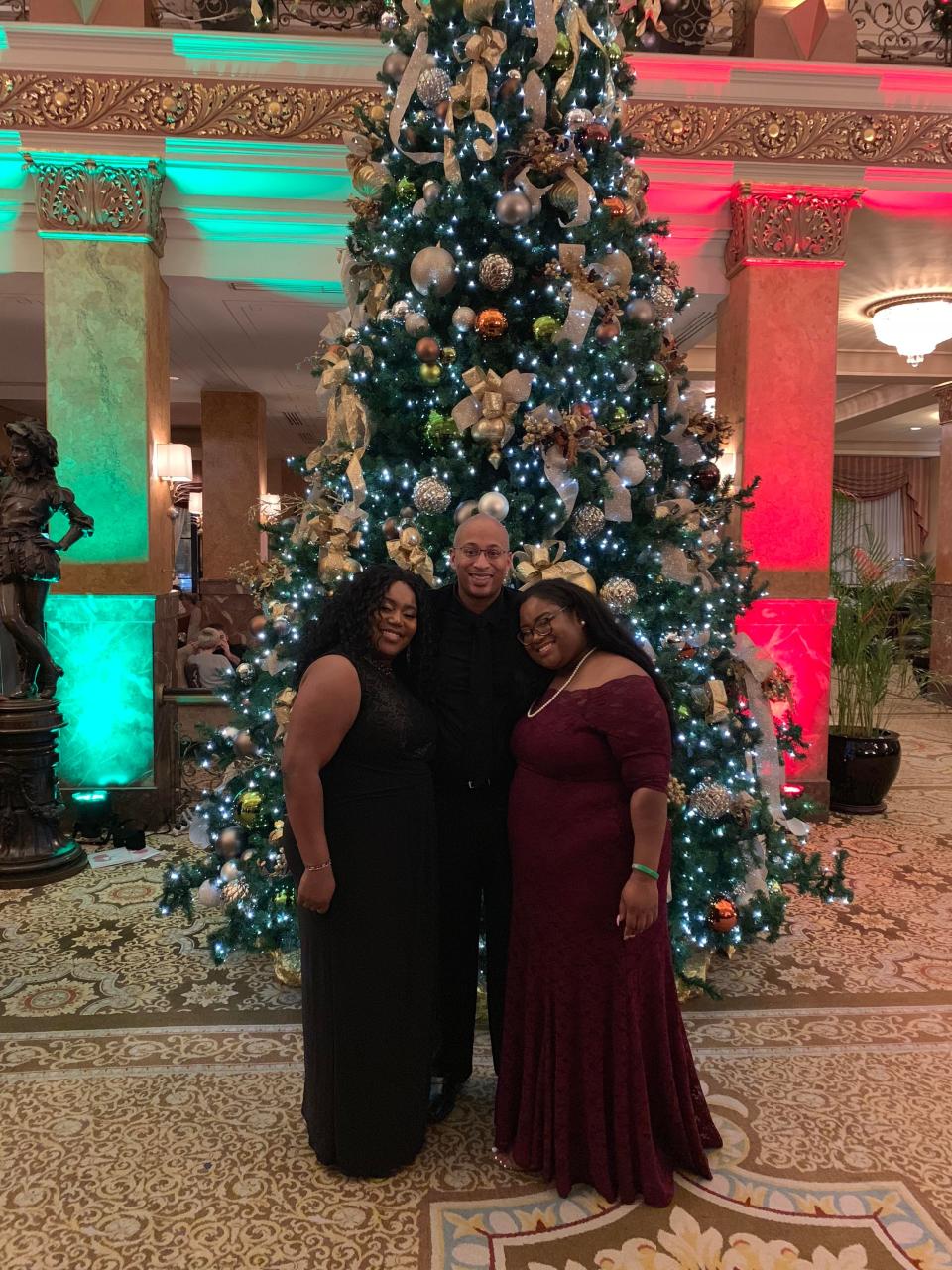 Keith Carrington, center, poses with his wife Tanzanique and daughter Cairee, during the holidays in this undated photo.