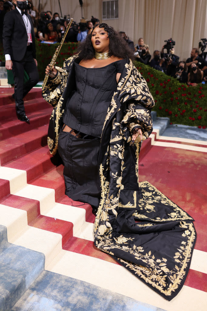 Lizzo wearing a gold-embroidered dress