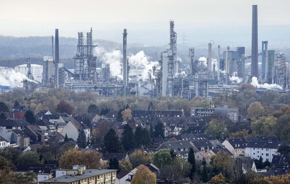 FILE - The BP oil refinery steams behind residential houses in Gelsenkirchen, Germany, Nov. 5, 2021. The IEA’s annual world energy outlook, which analyzes the global picture of energy supply and demand, was released Tuesday, Oct. 24, 2023. (AP Photo/Martin Meissner, File)