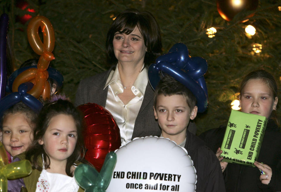 Cherie Blair, wife of the British Prime Minister Tony Blair surrounded by disadvantaged children after switching on the Christmas lights of the Downing Street festive tree outside the British Prime Minister's official residence, 10 Downing Street, Monday 12 December, 2005. PRESS ASSOCIATION Photo. Photo credit should read: Jane Mingay/PA   (Photo by Jane Mingay - PA Images/PA Images via Getty Images)