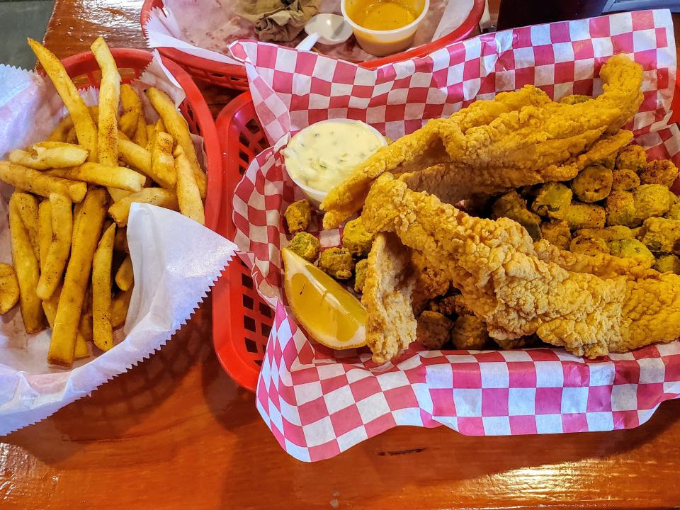 fried catfish and fries in red baskets